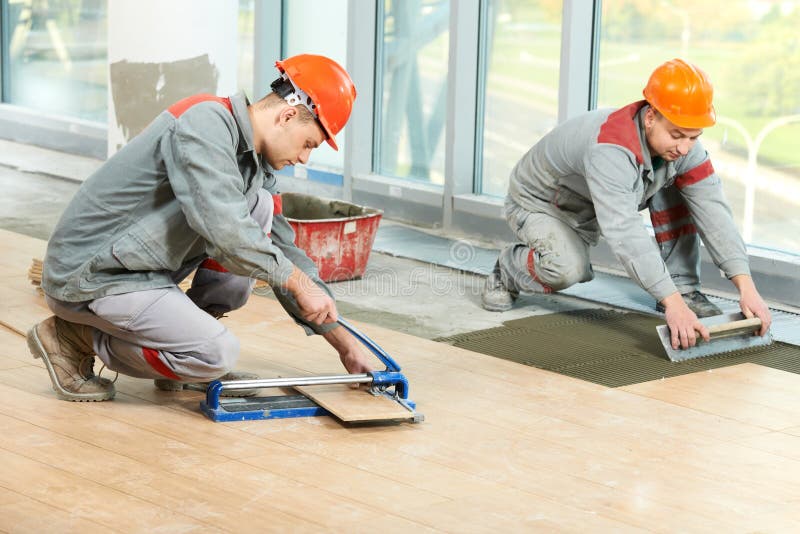 Two workers with construction materials